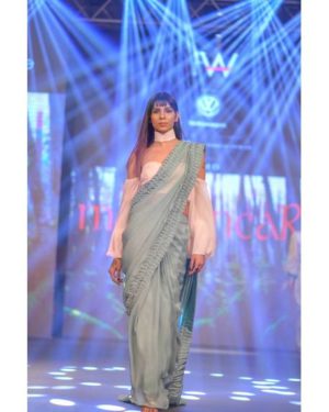 Green chiffon saree with texture with baby pink balloon sleeve blouse and choker